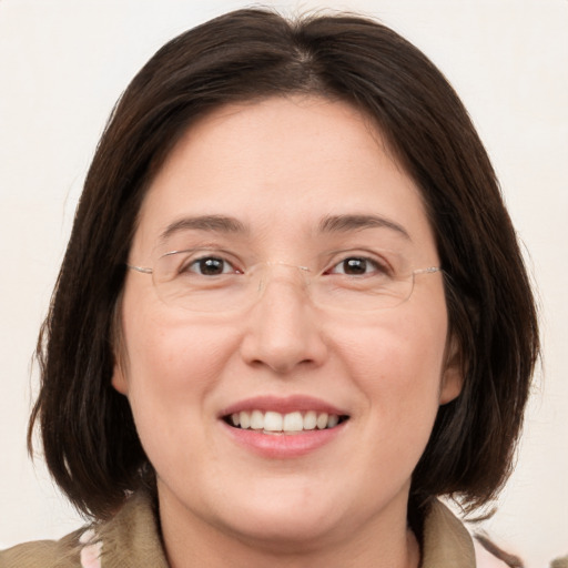 Joyful white adult female with medium  brown hair and brown eyes