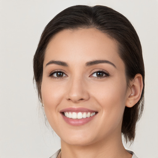 Joyful white young-adult female with medium  brown hair and brown eyes