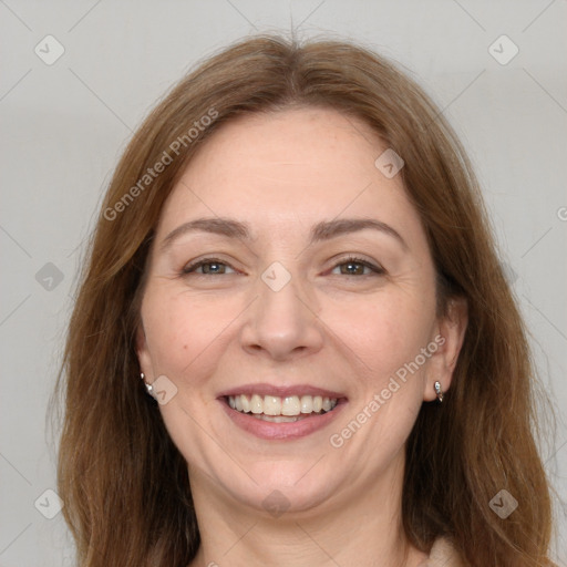 Joyful white adult female with long  brown hair and grey eyes