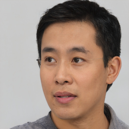 Neutral asian young-adult male with short  black hair and brown eyes