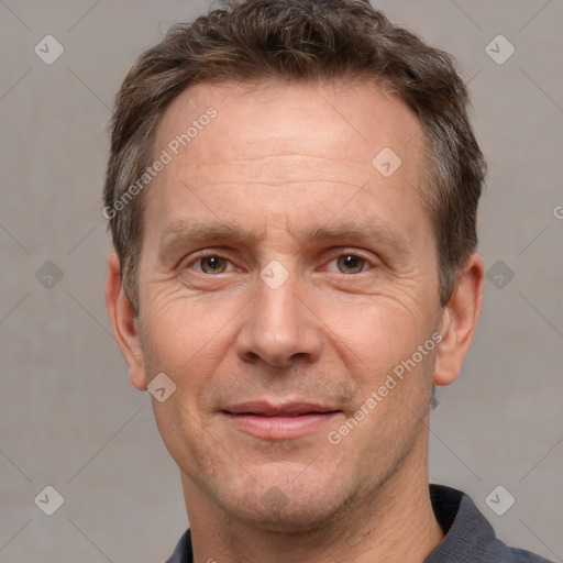 Joyful white adult male with short  brown hair and grey eyes