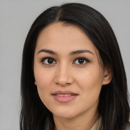 Joyful asian young-adult female with long  brown hair and brown eyes