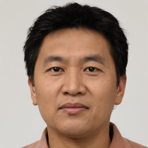 Joyful asian adult male with short  black hair and brown eyes