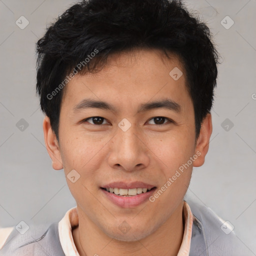 Joyful asian young-adult male with short  brown hair and brown eyes