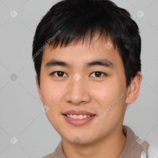 Joyful asian young-adult male with short  brown hair and brown eyes