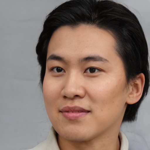Joyful asian young-adult male with medium  brown hair and brown eyes