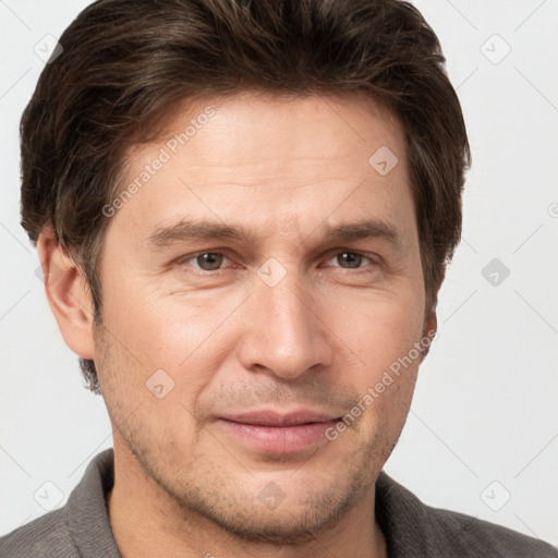 Joyful white adult male with short  brown hair and grey eyes