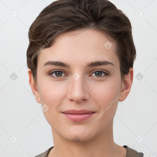 Joyful white young-adult female with short  brown hair and grey eyes