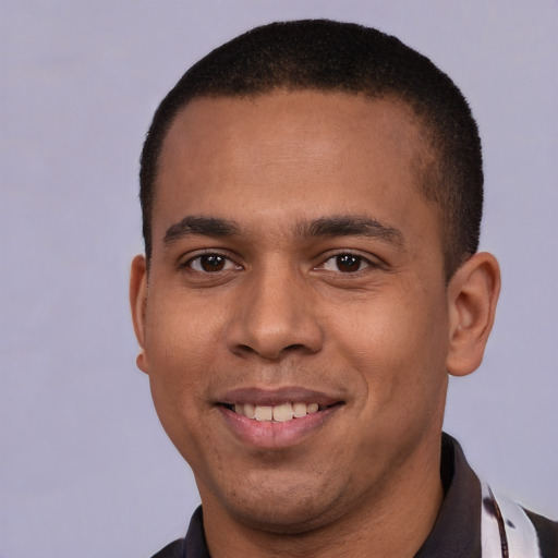 Joyful latino young-adult male with short  brown hair and brown eyes