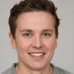 Joyful white adult male with short  brown hair and grey eyes