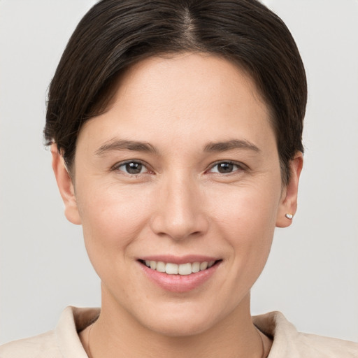 Joyful white young-adult female with short  brown hair and brown eyes