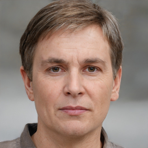 Joyful white adult male with short  brown hair and grey eyes