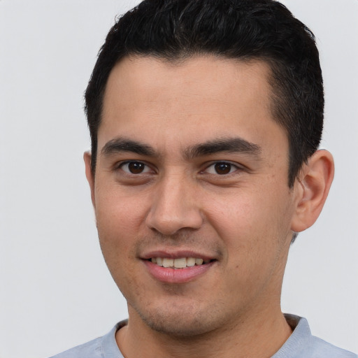 Joyful latino young-adult male with short  brown hair and brown eyes