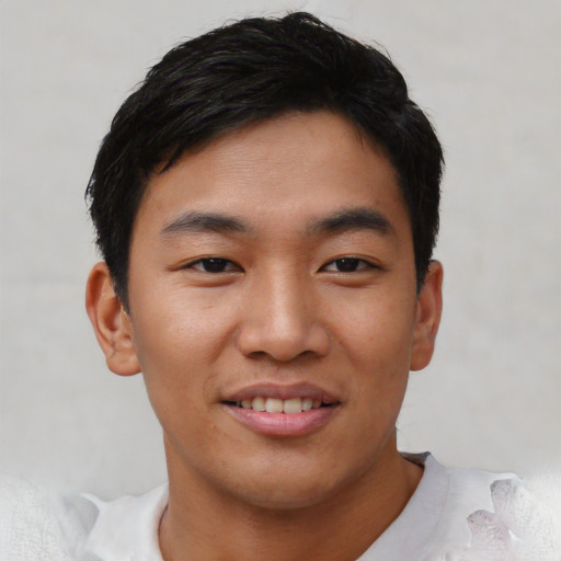 Joyful asian young-adult male with short  black hair and brown eyes