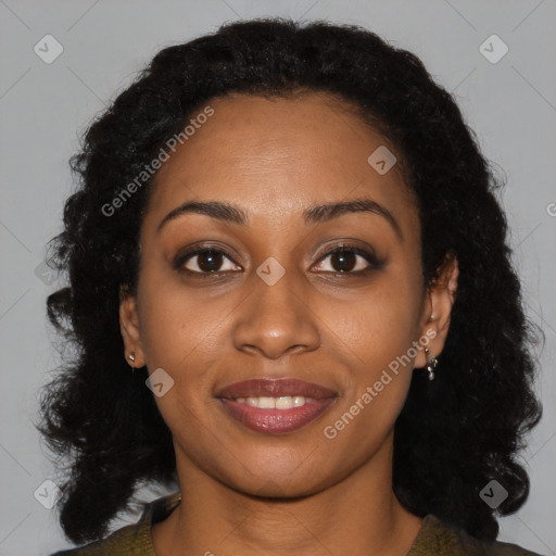 Joyful black young-adult female with long  brown hair and brown eyes