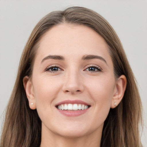 Joyful white young-adult female with long  brown hair and grey eyes