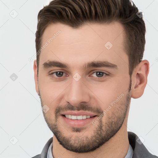 Joyful white young-adult male with short  brown hair and brown eyes