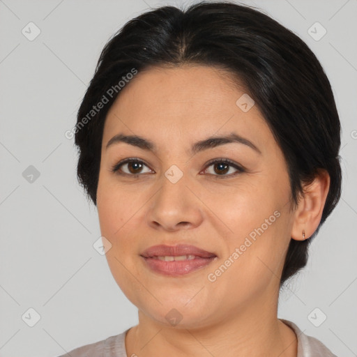 Joyful latino young-adult female with medium  brown hair and brown eyes