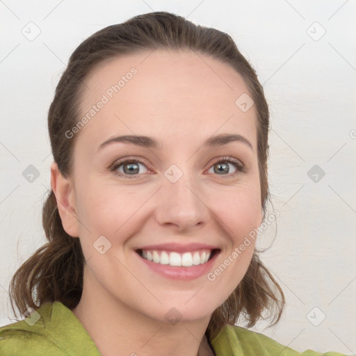 Joyful white young-adult female with medium  brown hair and grey eyes