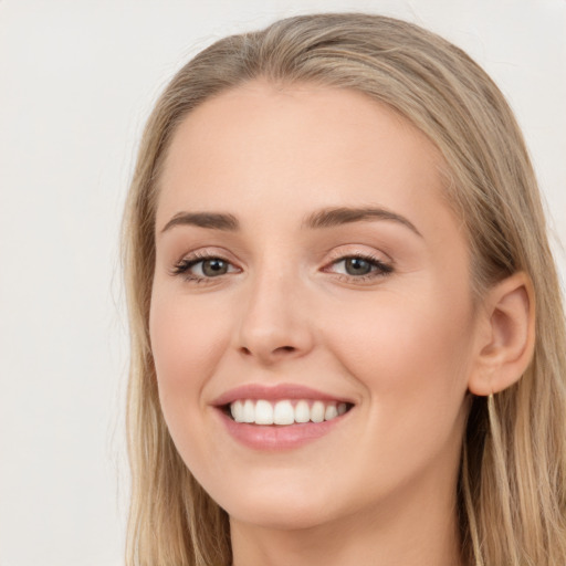 Joyful white young-adult female with long  brown hair and green eyes