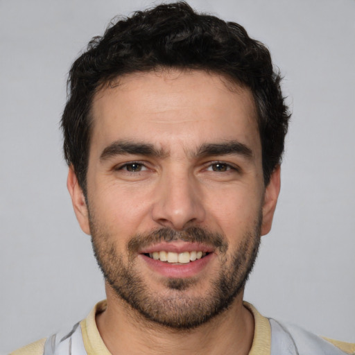 Joyful white young-adult male with short  black hair and brown eyes