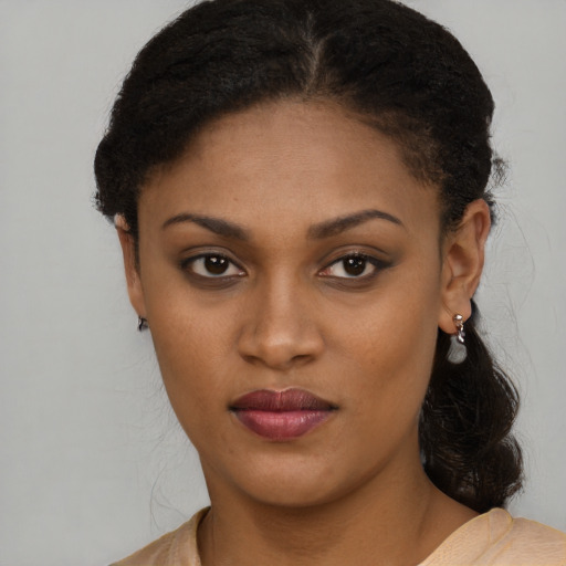 Joyful black young-adult female with short  brown hair and brown eyes