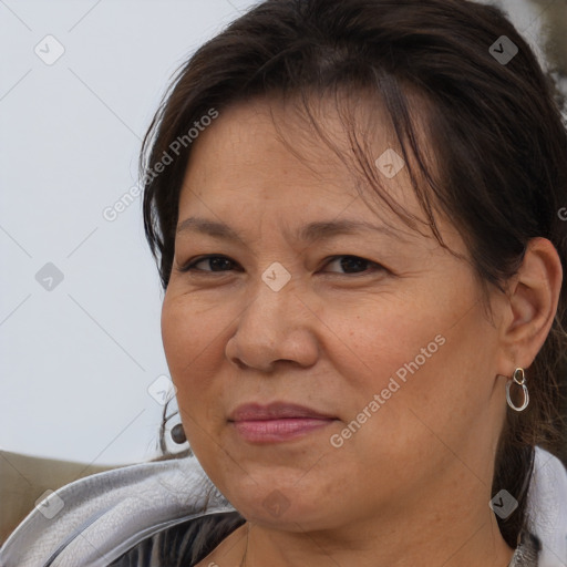 Joyful white adult female with medium  brown hair and brown eyes