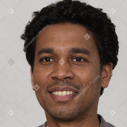 Joyful black young-adult male with short  black hair and brown eyes
