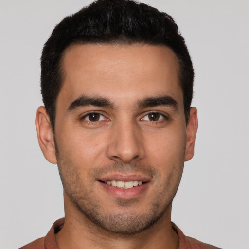 Joyful white young-adult male with short  brown hair and brown eyes