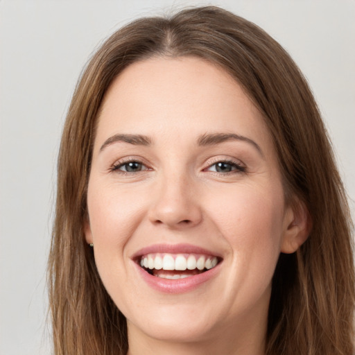 Joyful white young-adult female with long  brown hair and grey eyes