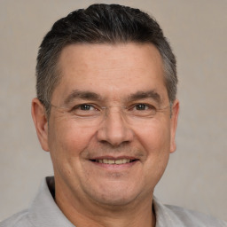 Joyful white adult male with short  brown hair and brown eyes