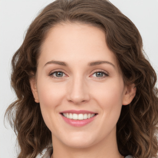 Joyful white young-adult female with long  brown hair and green eyes