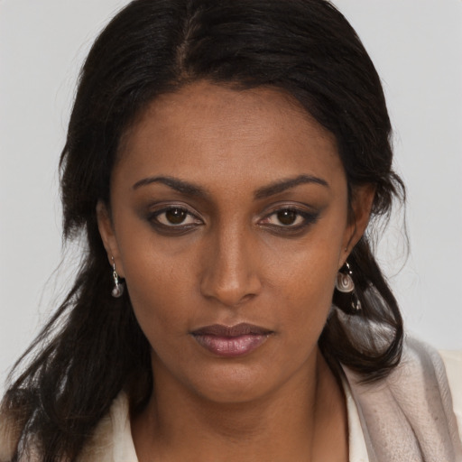 Neutral black young-adult female with long  brown hair and brown eyes