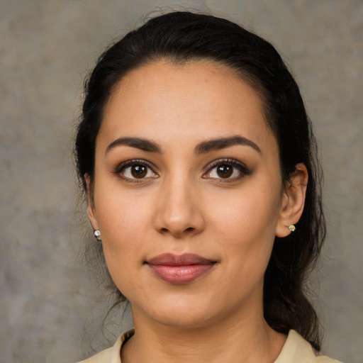 Joyful latino young-adult female with medium  black hair and brown eyes