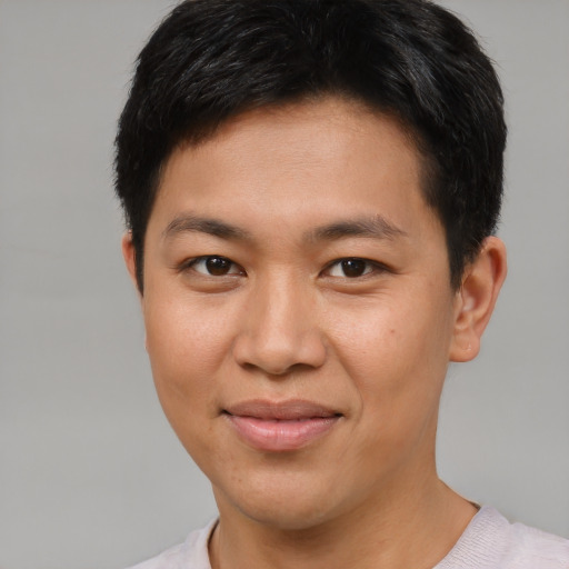 Joyful asian young-adult male with short  brown hair and brown eyes