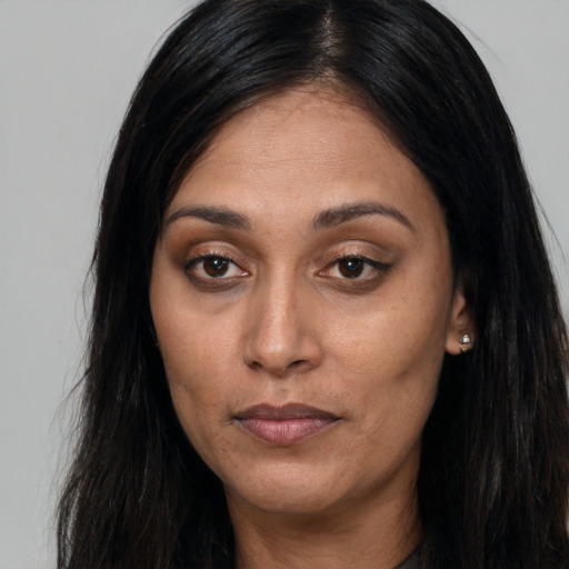 Joyful asian adult female with long  brown hair and brown eyes