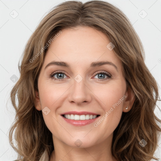 Joyful white young-adult female with long  brown hair and green eyes