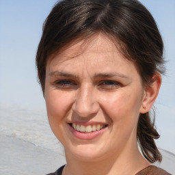 Joyful white adult female with medium  brown hair and brown eyes