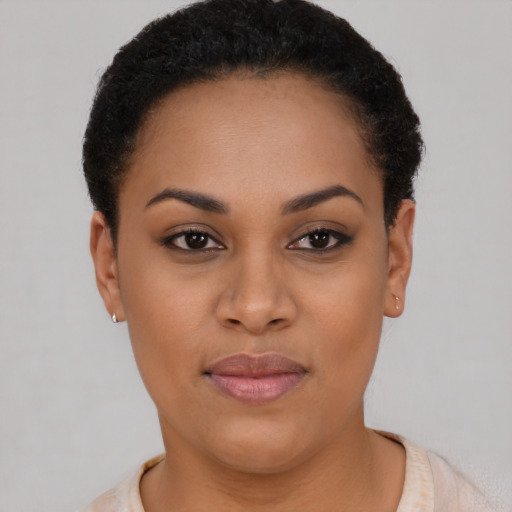 Joyful latino young-adult female with short  black hair and brown eyes
