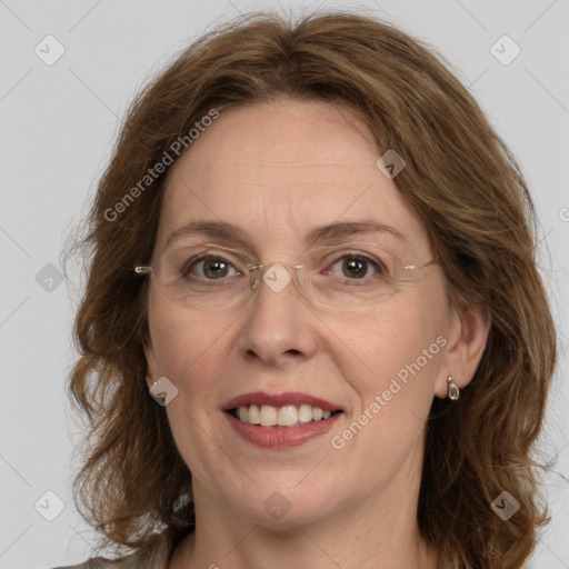 Joyful white adult female with long  brown hair and grey eyes