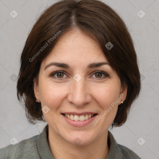 Joyful white adult female with medium  brown hair and brown eyes