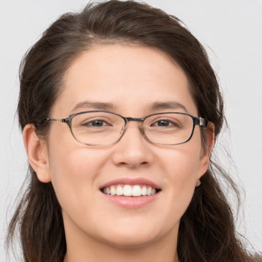 Joyful white young-adult female with long  brown hair and grey eyes