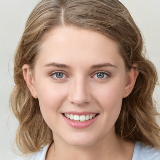 Joyful white young-adult female with medium  brown hair and blue eyes