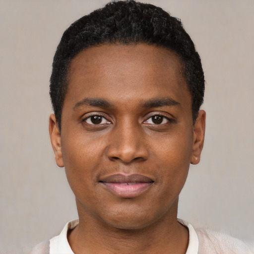 Joyful black young-adult male with short  black hair and brown eyes