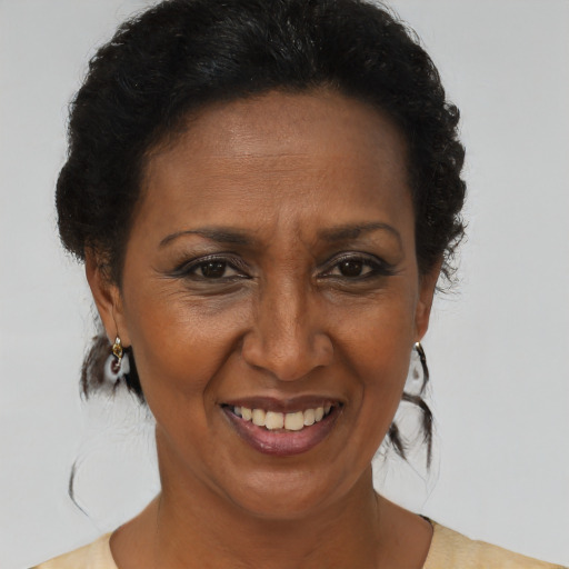 Joyful black adult female with short  brown hair and brown eyes