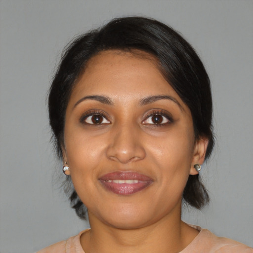 Joyful black young-adult female with medium  brown hair and brown eyes
