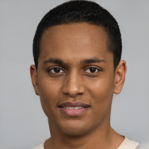 Joyful black young-adult male with short  black hair and brown eyes