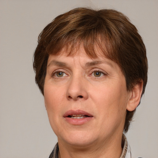 Joyful white adult female with short  brown hair and grey eyes