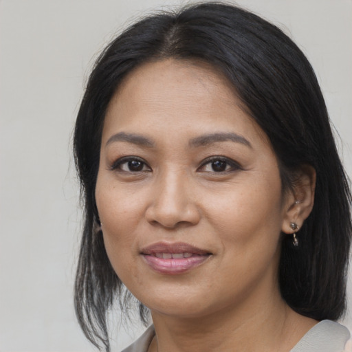 Joyful asian young-adult female with medium  black hair and brown eyes