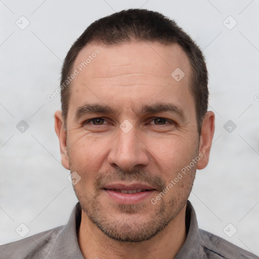 Joyful white adult male with short  brown hair and brown eyes